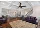 Open-concept living space shows hardwood floors, plush seating, and flows to a modern eat-in kitchen at 408 Brierley Dr, Apex, NC 27523