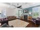 Bright living room features coffered ceilings, ceiling fan, fireplace and large area rug on wood floors at 408 Brierley Dr, Apex, NC 27523