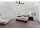 Comfortable main bedroom featuring neutral walls, tray ceiling, ceiling fan and plantation shutters for serene relaxation at 408 Brierley Dr, Apex, NC 27523