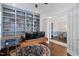 Home office features custom built-in bookshelves, hardwood floors, and an adjacent dining area at 408 Brierley Dr, Apex, NC 27523