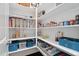 Walk-in pantry with white shelving, organized storage containers, and abundant food items at 408 Brierley Dr, Apex, NC 27523