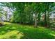 Large grassy backyard shaded by trees at 4309 Omni Pl, Raleigh, NC 27613