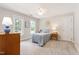 A bright bedroom featuring two windows, a bed, and soft, neutral colors at 4309 Omni Pl, Raleigh, NC 27613