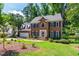 Stately brick home with blue shutters, lush lawn and mature trees at 4309 Omni Pl, Raleigh, NC 27613