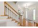 Light-filled foyer showcases hardwood floors, staircase, and a welcoming front door at 4309 Omni Pl, Raleigh, NC 27613