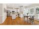 Bright kitchen with stainless appliances, white cabinetry, island, and hardwood floors at 4309 Omni Pl, Raleigh, NC 27613