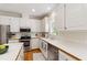 Kitchen showcasing white cabinets and stainless-steel appliances at 4309 Omni Pl, Raleigh, NC 27613
