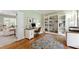 Bright office with hardwood floors, built-in shelving, and a well-lit workspace at 4309 Omni Pl, Raleigh, NC 27613