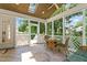 Relaxing sunroom features beautiful tile flooring, a ceiling fan, and outdoor views at 4309 Omni Pl, Raleigh, NC 27613