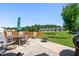 Back patio with seating area, fire pit, and view of lawn and neighboring homes at 437 Excalibur Dr, Morrisville, NC 27560