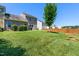 Spacious backyard featuring well-maintained lawn, tree, and privacy fence at 437 Excalibur Dr, Morrisville, NC 27560