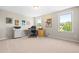 Bright bedroom with two windows, neutral carpet and home office setup at 437 Excalibur Dr, Morrisville, NC 27560
