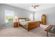 Bright bedroom with natural light, a ceiling fan, and neutral carpeting at 437 Excalibur Dr, Morrisville, NC 27560