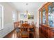 Bright dining room with hardwood floors, a classic hutch, and elegant wainscoting detail at 437 Excalibur Dr, Morrisville, NC 27560