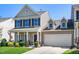 Charming two-story home featuring a welcoming front porch, attached garage, and meticulously landscaped front yard at 437 Excalibur Dr, Morrisville, NC 27560