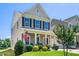Inviting two-story home with a covered front porch, well-maintained lawn, and attached two-car garage at 437 Excalibur Dr, Morrisville, NC 27560