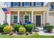 Cozy front porch with decorative stone accents, a ceiling fan, and colorful landscaping at 437 Excalibur Dr, Morrisville, NC 27560