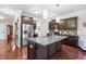 Modern kitchen with granite countertops, stainless steel appliances, and dark wood cabinetry at 437 Excalibur Dr, Morrisville, NC 27560