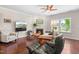 Comfortable living room with a fireplace, hardwood floors, and a ceiling fan at 437 Excalibur Dr, Morrisville, NC 27560