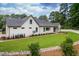Spacious backyard with a well-maintained lawn, brick accents, and landscaped borders at 4412 Pamlico Dr, Raleigh, NC 27609