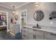 Dual vanities in an elegant bathroom connecting to a large walk-in closet at 4412 Pamlico Dr, Raleigh, NC 27609