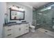 Modern bathroom featuring granite countertop vanity and glass enclosed shower with gray tiling at 4412 Pamlico Dr, Raleigh, NC 27609