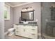 Bathroom featuring gray walls, white vanity with stone countertop, and tiled shower at 4412 Pamlico Dr, Raleigh, NC 27609