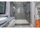 Bathroom featuring a glass shower with gray tile, white vanity and stone countertop at 4412 Pamlico Dr, Raleigh, NC 27609