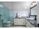 Bright bathroom featuring double sinks, vanity, and a glass-enclosed shower at 4412 Pamlico Dr, Raleigh, NC 27609