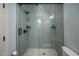 Sleek bathroom shower with gray tile and a glass door at 4412 Pamlico Dr, Raleigh, NC 27609