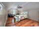Spacious bedroom featuring hardwood floors, seating, and a large ceiling fan at 4412 Pamlico Dr, Raleigh, NC 27609