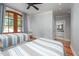 Bedroom with two beds, ceiling fan, wood floors, French doors to outside, and bathroom at 4412 Pamlico Dr, Raleigh, NC 27609