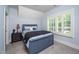 Comfortable bedroom featuring a stylish bed and window with plantation shutters at 4412 Pamlico Dr, Raleigh, NC 27609