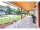 Spacious covered porch with stone flooring, wooden ceiling, and charming views of the manicured front yard at 4412 Pamlico Dr, Raleigh, NC 27609