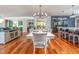 Dining area with table set for six, next to a modern kitchen, perfect for entertaining at 4412 Pamlico Dr, Raleigh, NC 27609