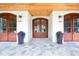 Elegant entrance showcasing the stunning front doors and decorative planters for added curb appeal at 4412 Pamlico Dr, Raleigh, NC 27609