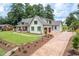 Expansive home with a well-manicured lawn, circular driveway, and attached garage for added convenience at 4412 Pamlico Dr, Raleigh, NC 27609