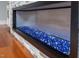 Close up of the fireplace with decorative glass stones at 4412 Pamlico Dr, Raleigh, NC 27609