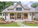 Stylish front exterior showcasing the covered porch, wooden pillars, and the lovely landscaped walkway at 4412 Pamlico Dr, Raleigh, NC 27609
