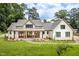 Beautiful, bright home featuring a manicured lawn, walkway to the entryway, and a stylish, covered porch at 4412 Pamlico Dr, Raleigh, NC 27609