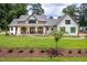 Inviting exterior of a bright, white home with a manicured lawn and charming walkway to the front door at 4412 Pamlico Dr, Raleigh, NC 27609