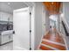 Hallway with hardwood floors leading to other areas of the home, and a set of stairs at 4412 Pamlico Dr, Raleigh, NC 27609