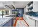 Bright kitchen features a large island, custom cabinetry and wine cooler at 4412 Pamlico Dr, Raleigh, NC 27609