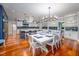 A spacious kitchen area and dining table with hardwood floors, and elegant lighting at 4412 Pamlico Dr, Raleigh, NC 27609