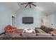 Spacious living room with ceiling fan, comfortable seating, and mounted television at 4412 Pamlico Dr, Raleigh, NC 27609