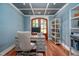 Home office with coffered ceiling, wood floors, and large desk with comfortable chair at 4412 Pamlico Dr, Raleigh, NC 27609