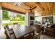 Outdoor living space with a fireplace, grill, and wooden ceiling at 4412 Pamlico Dr, Raleigh, NC 27609