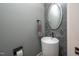 Elegant powder room with decorative mirror, vessel sink, stylish faucet, and modern fixtures at 4412 Pamlico Dr, Raleigh, NC 27609
