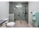 Walk-in shower with gray subway tiling, bench seating, and a glass door enclosure at 4412 Pamlico Dr, Raleigh, NC 27609