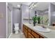 Bathroom featuring double sinks with wooden cabinets, a large mirror, and a glass-enclosed shower at 4600 Townesbury Ln, Raleigh, NC 27612